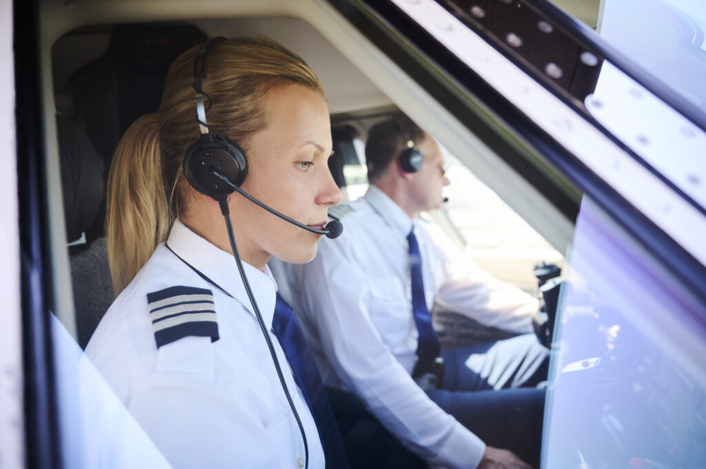 female and male pilots flying private jet managed my private jet center
